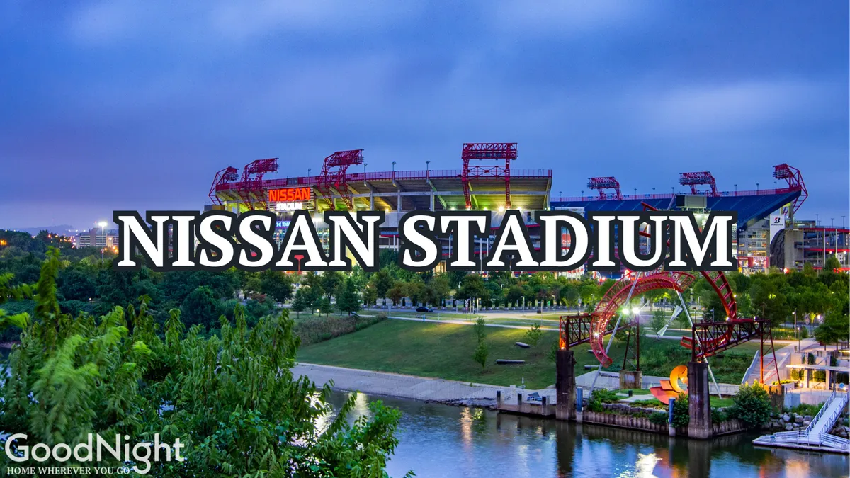 An exterior shot of Nissan Stadium set near a riverfront park, with lush greenery and open space in the foreground and the stadium's distinctive structure in the background. The scene feels energetic and inviting, highlighting a key Nashville attraction.